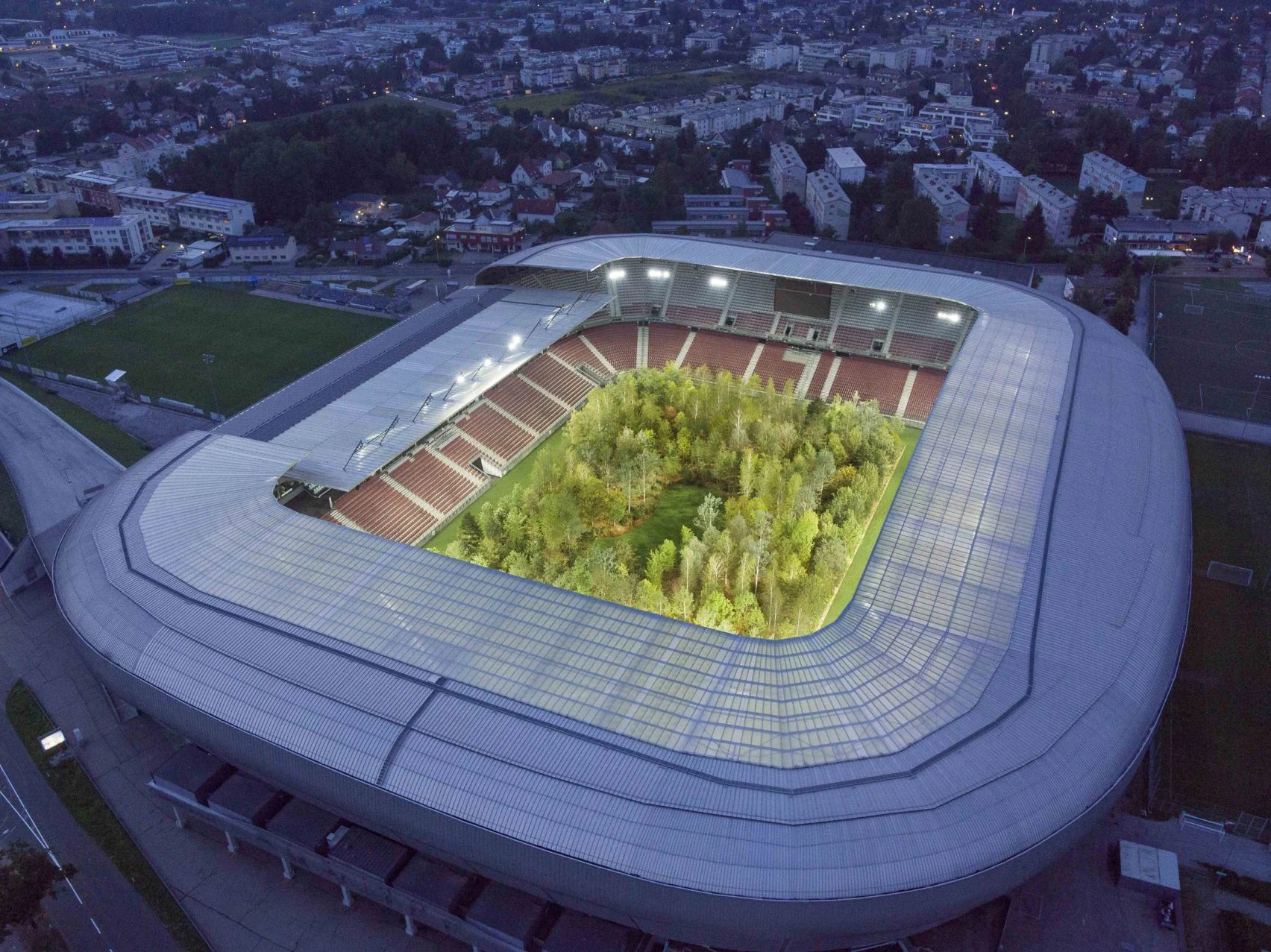 for-forest-flaus-littmann-worthersee-stadium-klagenfurt-austria-drone-photo-unimo_dezeen_2
