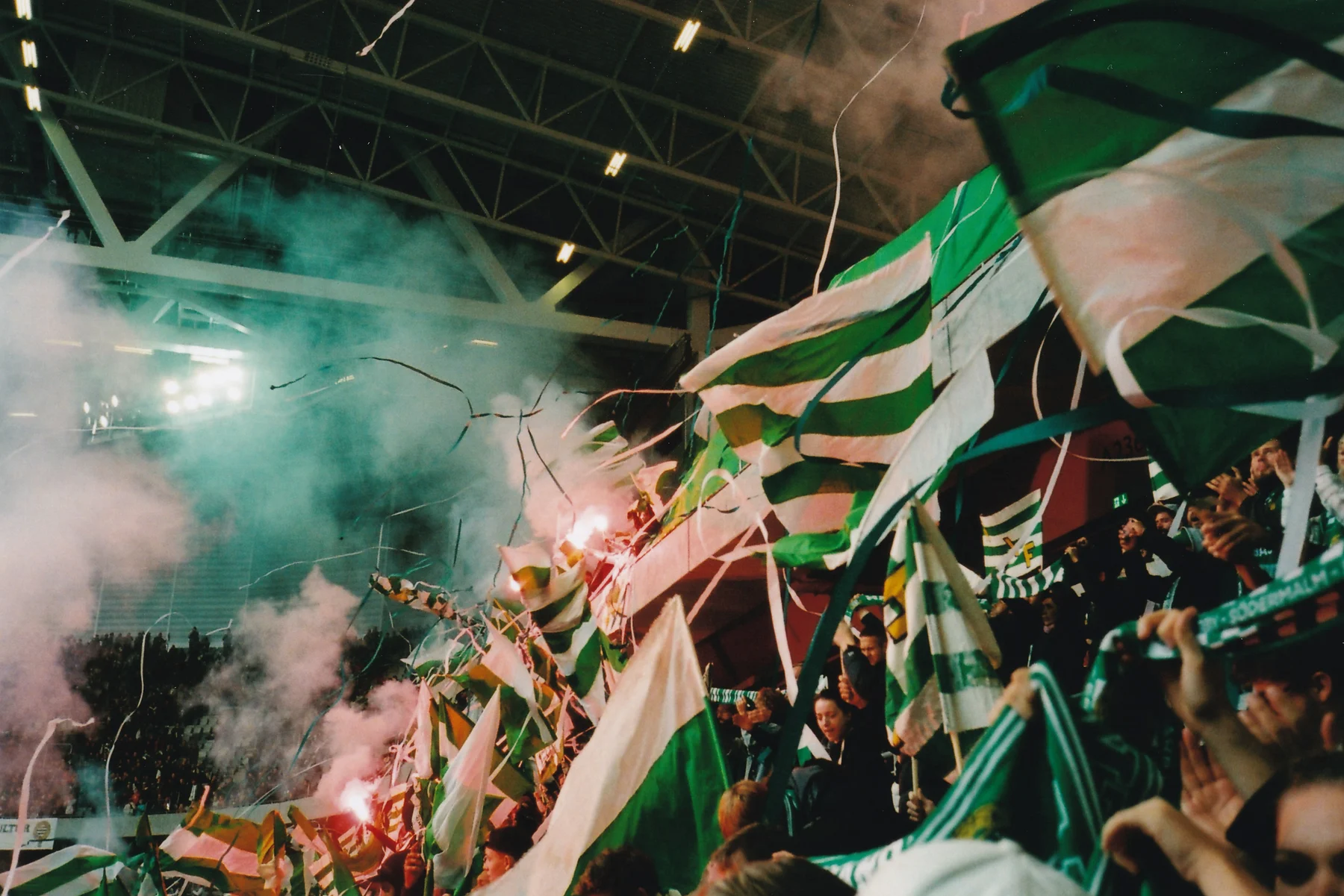 Hammarby supporters with green and white flags, smoke and streamers